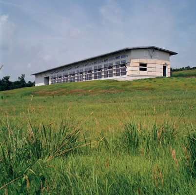Natural ventilation includes operable windows set high on the north elevation. Southern windows are protected from the hot summer sun by continuous louvers. The natural prairie was maintained and reseeded in disrupted areas following construction.
